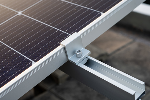 Close up on the clamp at the edge of the solar panel.