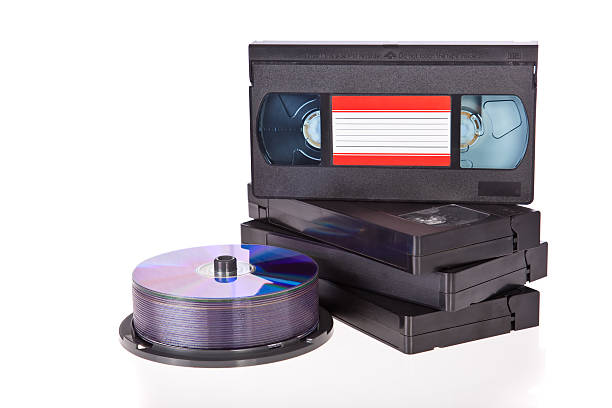 istock Video tapes with a DVD disc isolated on white 183151720