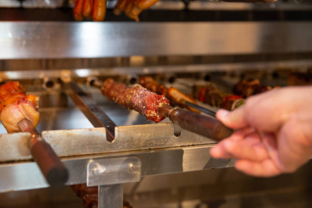 istock Unrecognizable Chef Placing Meat Skewer on Roasted Grill 1831520569