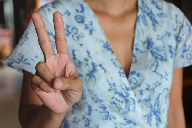 istock Unrecognizable Woman Posing a Peace Sign 1831520582