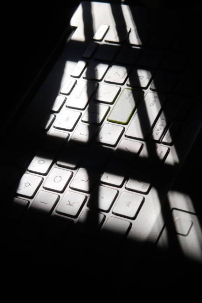 istock shadowy picture of laptop keyboard kept near window 1831521773