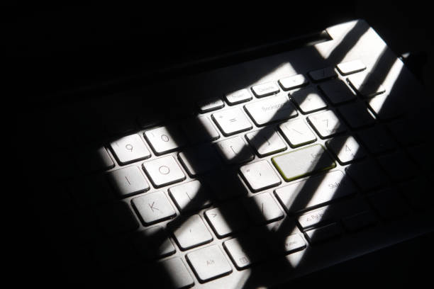 istock shadowy picture of laptop keyboard kept near window 1831521775