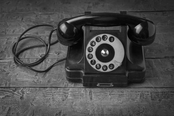 istock A retro telephone set on a wooden table. 1831530219