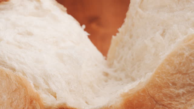 Freshly Baked Loaf of Bread Being Halved