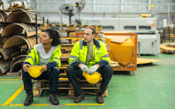 istock Cardboard workers chat, share ideas during breaks, foster togetherness, create positive workspace. 1831538267