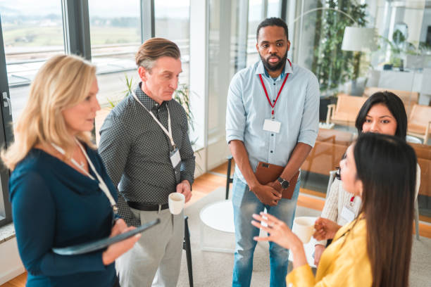 istock Asian Female Entrepreneur Explaining Something to Coworkers 1831540379