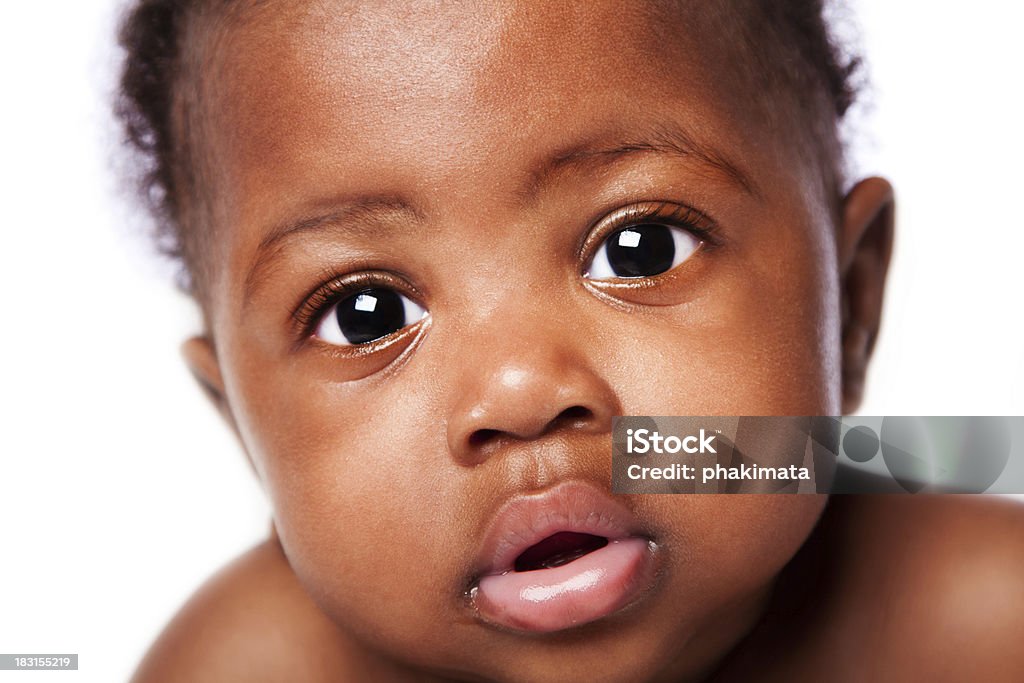 Innocent African baby face Closeup of cute adorable beautiful face of African baby with innocent expression, on white. Baby - Human Age Stock Photo