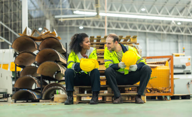 istock Cardboard workers chat, share ideas during breaks, foster togetherness, create positive workspace. 1831552542