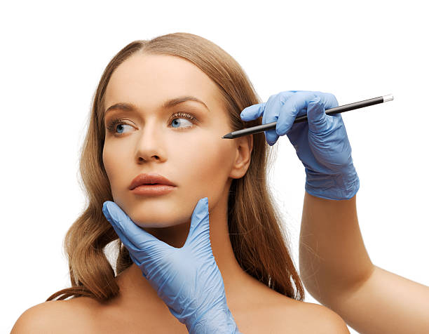 istock woman face and beautician hands with pencil 183155445