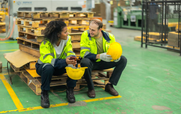 istock Cardboard workers chat, share ideas during breaks, foster togetherness, create positive workspace. 1831559240