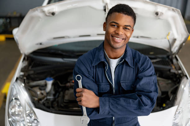 istock Happy mechanic working at an auto repair shop 1831594313
