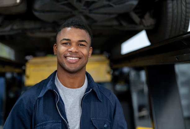 istock Happy mechanic working at a car garage 1831594316