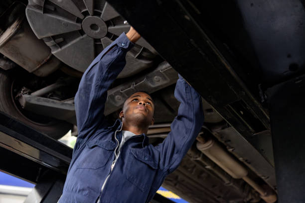 istock Mechanic repairing a car on an elevator at a garage 1831594317