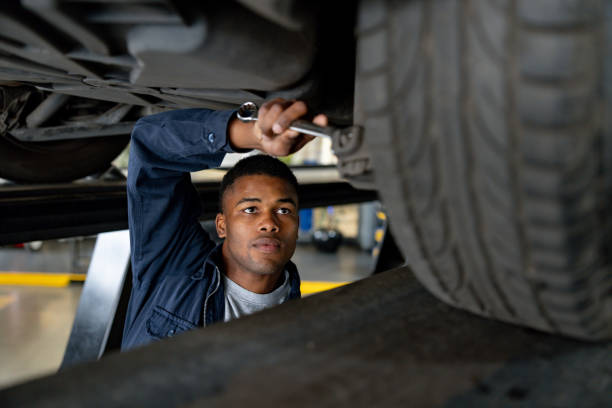 istock Mechanic repairing a car using a wrench at a garage 1831594319