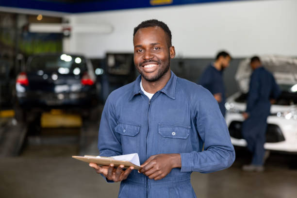 istock Happy mechanic working at an auto repair shop 1831594837