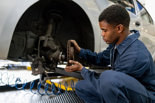 istock Mechanic fixing a flat tire on a car at a garage 1831594841