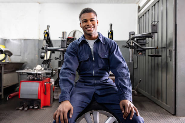 istock Happy mechanic working at an auto repair shop 1831594859