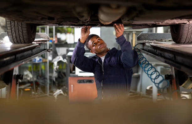 istock Mechanic working under a car at a garage 1831595380