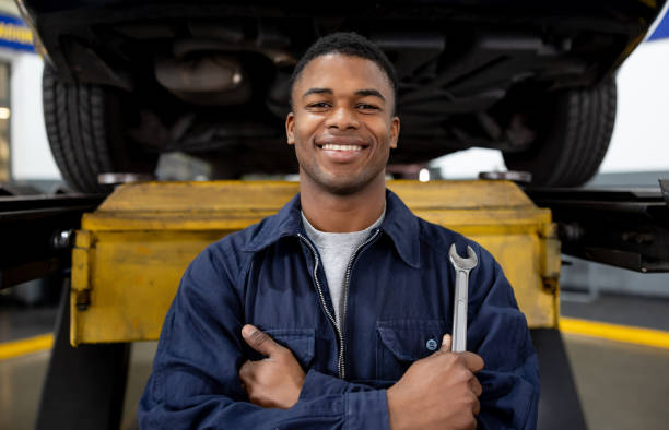 istock Happy mechanic working at a garage 1831595384