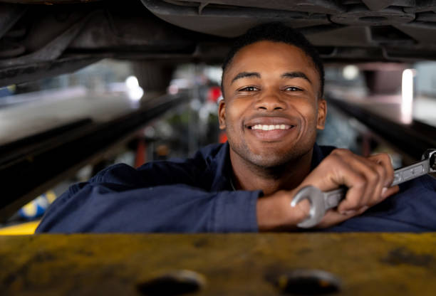 istock Happy mechanic working at a garage 1831595386