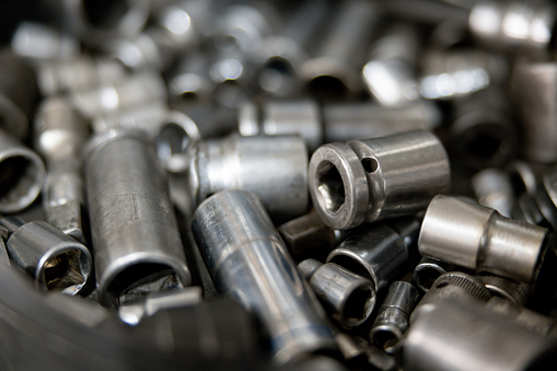 Close-up on a pile of socket wrench heads at a car garage - vehicle breakdown concepts