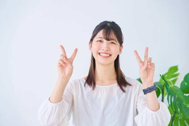 istock young woman doing peace sign 1831597947