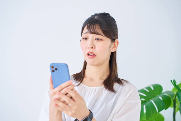 istock A young woman looking at her smartphone with an anxious expression 1831608402