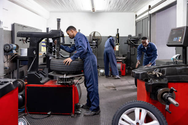 istock Mechanics fixing flat tires at a car garage 1831625479