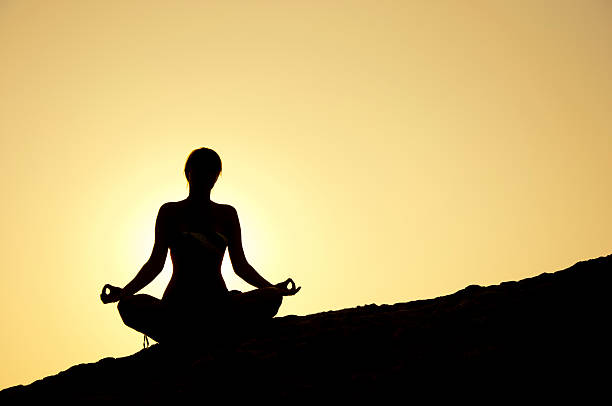 istock yoga pose silhouette at sunrise 183163017