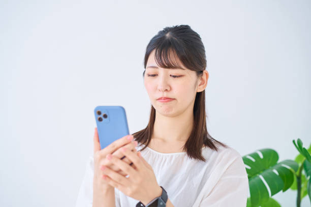 istock A young woman looking at her smartphone with an anxious expression 1831637020