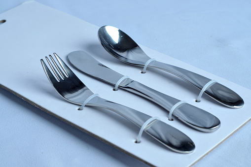 forks spoons and knives eating utensils are neatly arranged in a paper board panel packaging