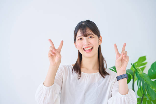 istock young woman doing peace sign 1831645881