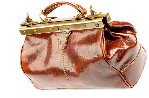 Traveling Bag Ginger Expensive Leather Traveling Bag with Gold Details isolated on white background leather medical bag stock pictures, royalty-free photos & images