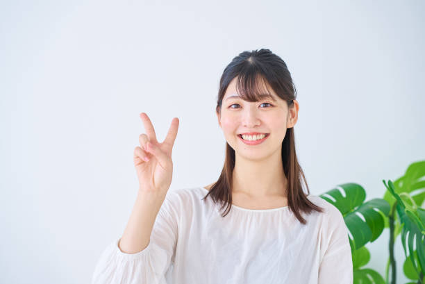 istock young woman doing peace sign 1831662576