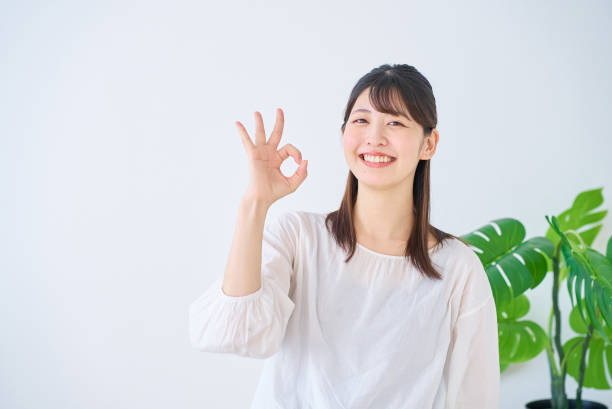 Young woman giving an OK hand sign