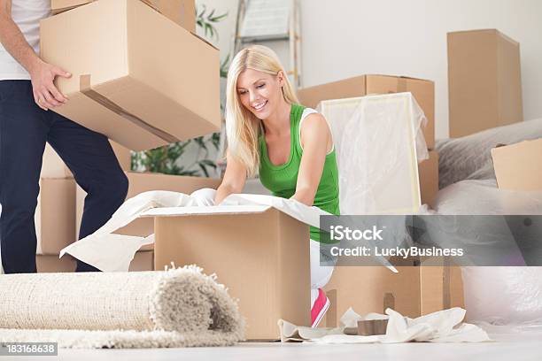 Happy Woman Unpacking In New Home Stock Photo - Download Image Now - Adult, Adults Only, Apartment