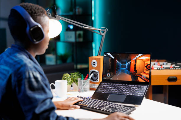 istock Black individual playing game on laptop 1831735570