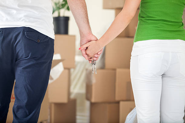 istock Couple holding hands together in new home 183177251
