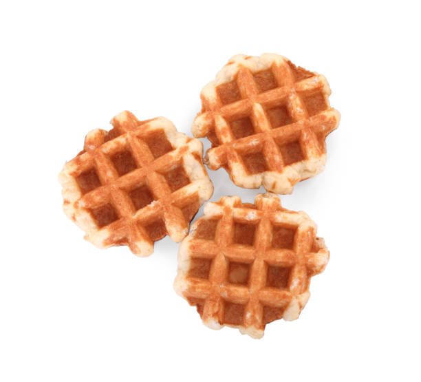 istock Many delicious Belgian waffles isolated on white, top view 1831780716