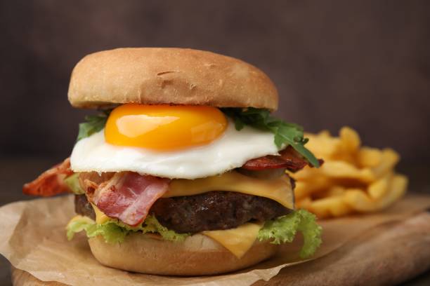 istock Delicious burger with fried egg served on table, closeup 1831793525