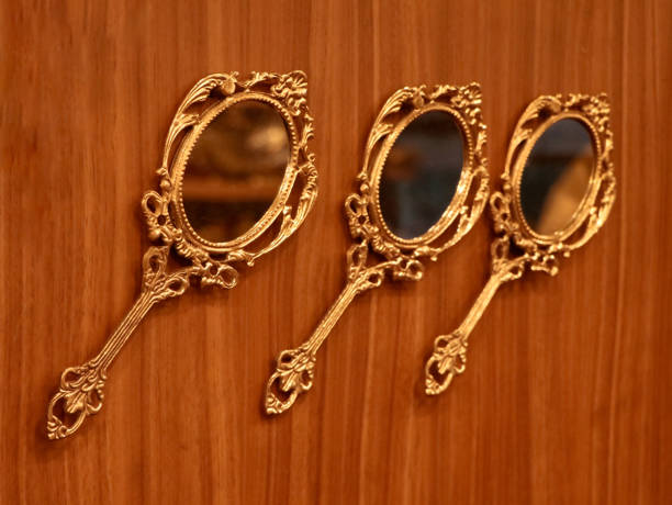 istock three vintage round golden hand mirrors 1831794562