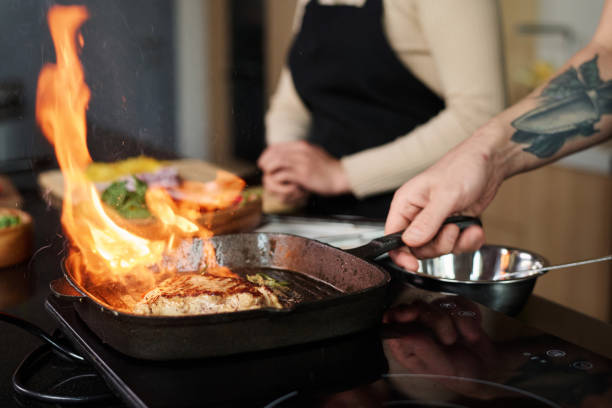 istock Man Cooking Meat Over High Heat 1831805001