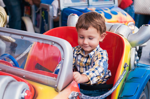 Little boy riding a car stock photo
