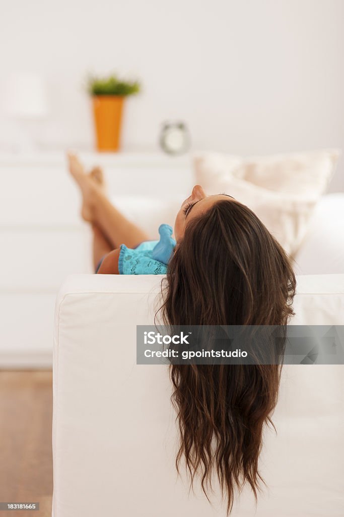 Woman with long hair relaxing on the couch Adult Stock Photo