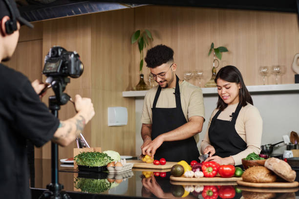 istock Man and Woman Cutting Vegetables on Culinary Show Set 1831824372