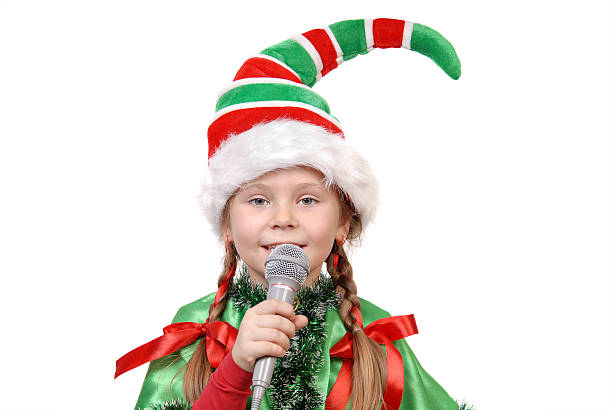 Cтоковое фото Девушка-Santa's Эльф с микрофоном