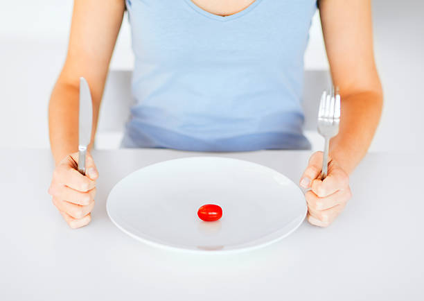 istock woman with plate and one tomato 183186163