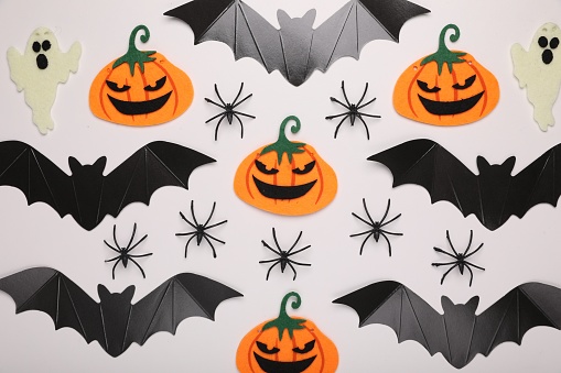 Flat lay composition with Halloween decor on white background