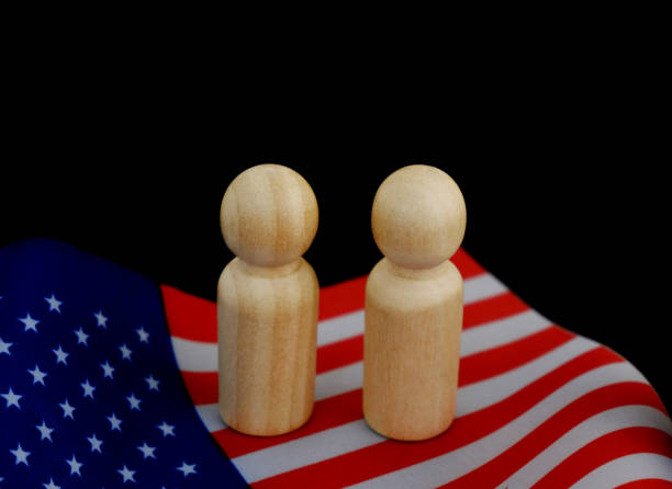 istock People figures as candidates on US national flag on black background. 1831866509