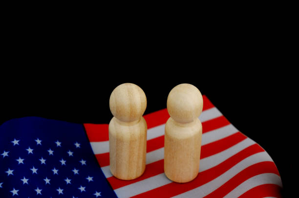 istock People figures as candidates on US national flag on black background. 1831866511